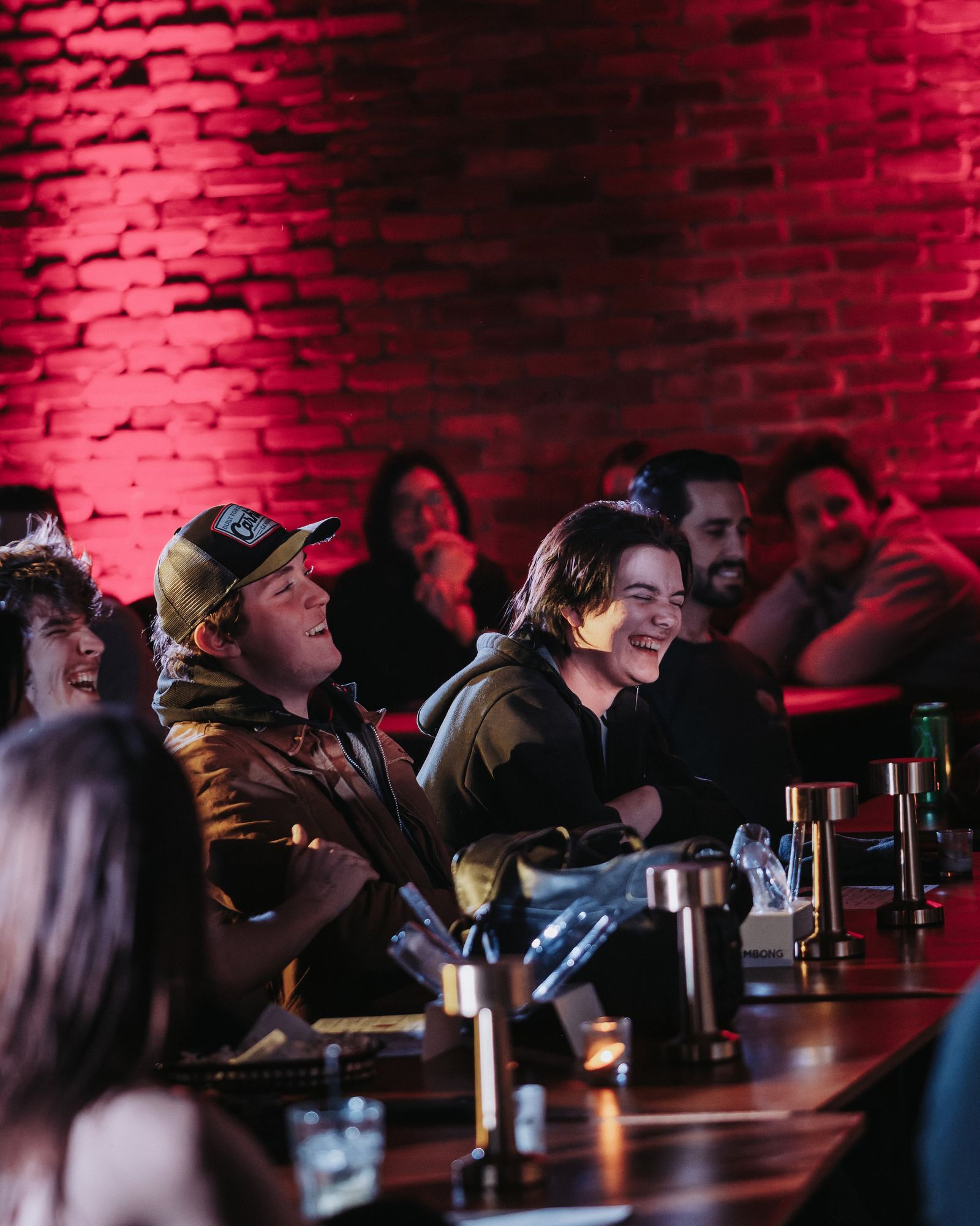 A table of friends laughing at the show