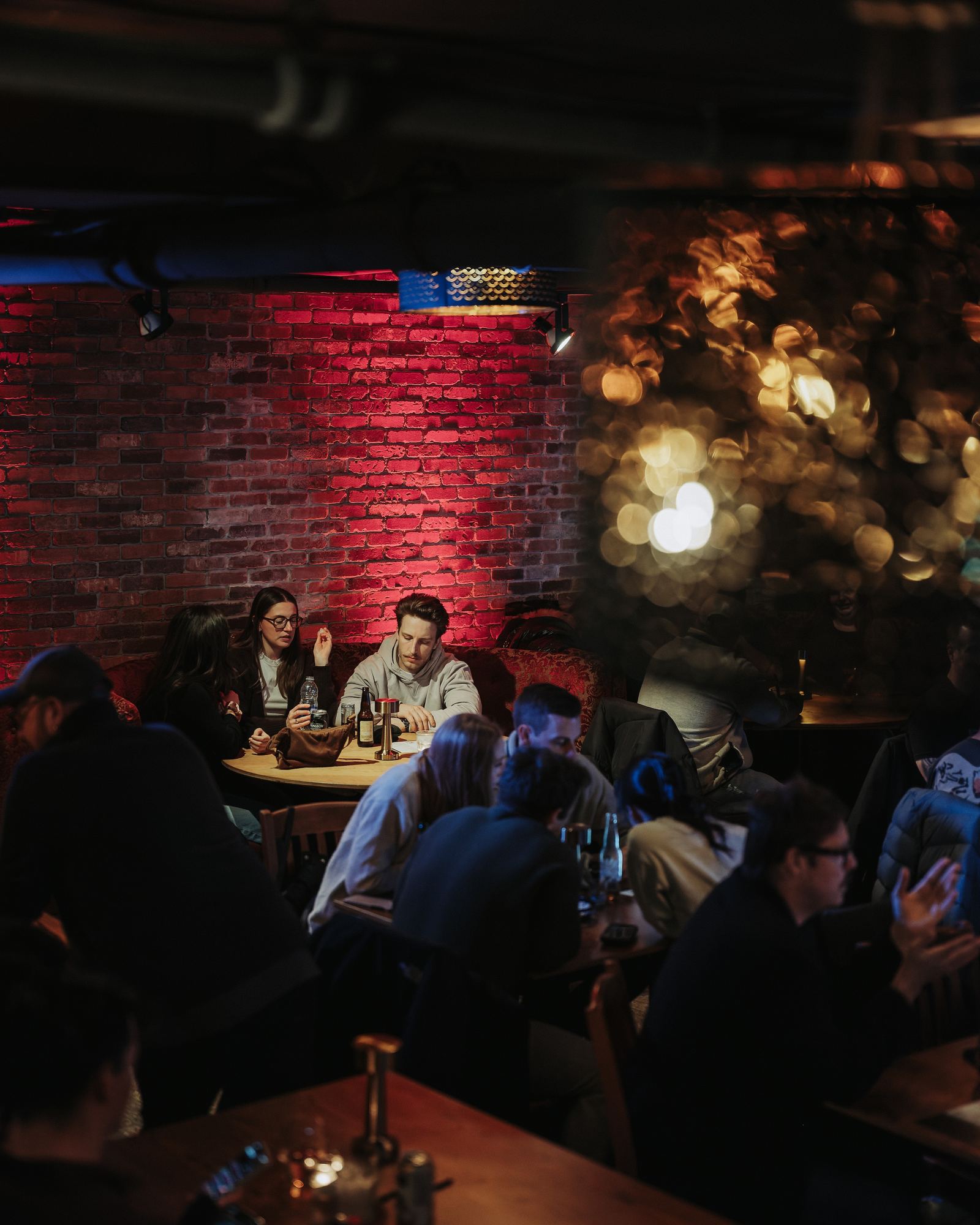 Tables under the red brick wall, full house